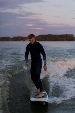 Man wake surfing in lake.