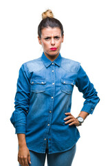 Young beautiful woman over isolated background skeptic and nervous, frowning upset because of...