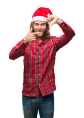 Young handsome man with long hair wearing santa claus hat over isolated background smiling making frame with hands and fingers with happy face. Creativity and photography concept.