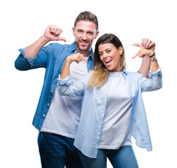 Young couple in love over isolated background looking confident with smile on face, pointing...