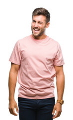 Fototapeta premium Young handsome man over isolated background winking looking at the camera with sexy expression, cheerful and happy face.