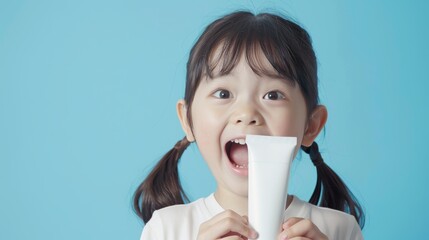 Cheerful little child holding a product. On an isolated background.