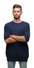 Fototapeta premium Young handsome man wearing winter sweater over isolated background skeptic and nervous, disapproving expression on face with crossed arms. Negative person.