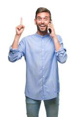 Young handsome man speaking on the phone over isolated background surprised with an idea or question pointing finger with happy face, number one