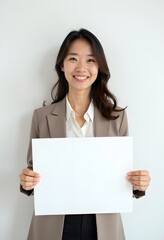 Naklejka premium Professional Woman Holding Blank Sign in Business Attire for Customizable Corporate Message or Branding
