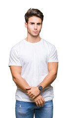 Young handsome man wearing white t-shirt over isolated background skeptic and nervous, frowning upset because of problem. Negative person.