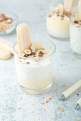 Milk mousse dessert with nuts in glasses