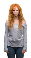 Young redhead woman skeptic and nervous, frowning upset because of problem. Negative person.