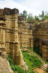 Natural rock formation with a unique and intricate pattern of vertical ridges and grooves, rough texture. Pha Chor, Grand Canyon of Chiang Mai, Thailand. Natural phenomenon