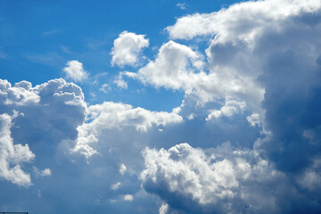 Cumulus clouds. White clouds on the blue sky close-up.