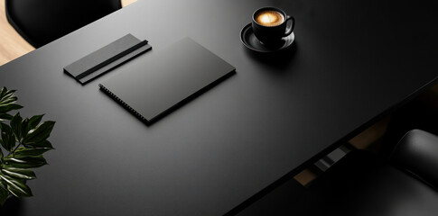 Office black leather desk with notebook and coffee cup