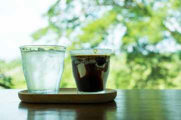Dirty coffee iced Mocha freeze milk pour espresso shot in a cup of coffee on wood tray at cafe