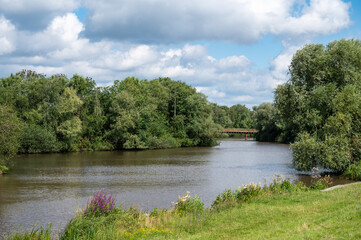 Fototapeta premium Green banks of the River Ochtum at the Kladdinger Wiesen at the borders of Bremen, Germany
