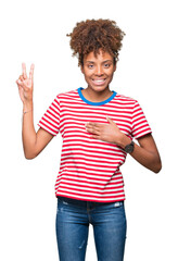 Beautiful young african american woman over isolated background Swearing with hand on chest and...