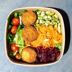 Bowl of peas, vegetables and falafel, a vegan dish in Bremen, Germany