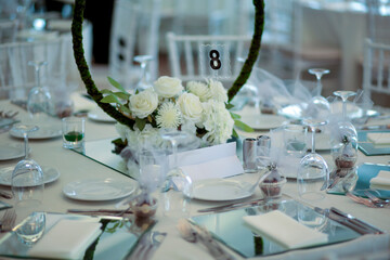 Elegant White Floral Centerpiece on Mirrored Table - Sophisticated Wedding Dinner Setting