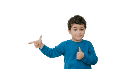 cheerful young boy in a blue shirt giving a thumbs-up and pointing playfully, exuding confidence and positivity