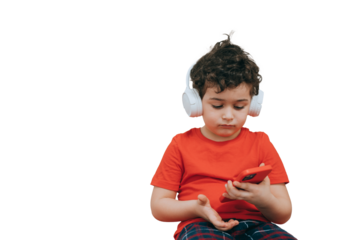 Young boy in a red shirt, smiling and holding a smartphone while listening to music, radiating happiness and curiosity
