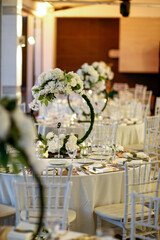 Elegant White Floral Centerpiece on Mirrored Table - Sophisticated Wedding Dinner Setting