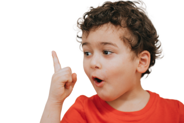 Excited toddler looks aside with surprised face at copy space rising index finger up. Mockup, sale, discount, Black Friday. `cute curly boy pointing at empty space screaming , amazed. Wow
