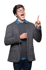 Young handsome business man wearing glasses over isolated background pointing finger up with successful idea. Exited and happy. Number one.