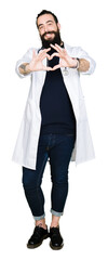 Obraz premium Doctor with long hair wearing medical coat and stethoscope smiling in love showing heart symbol and shape with hands. Romantic concept.