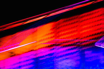 A colorful, abstract image with a red and blue line. The colors are bright and vibrant, giving the image a lively and energetic feel