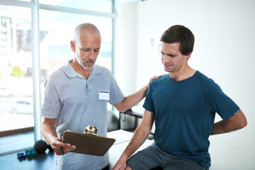 Physiotherapist, man and back pain for consultation, health and wellness for sore muscle or...