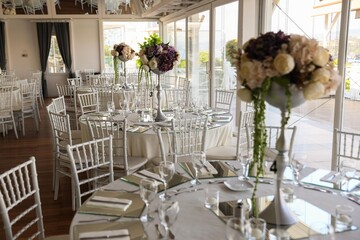 Romantic wedding table setting with floral arrangements and greenery