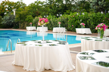 Romantic outdoor wedding setting with a pool, perfect for a summer celebration