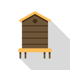 Simple wooden beehive standing on four legs, with a long shadow