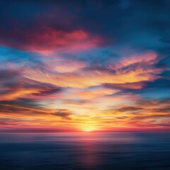 Stunning sunset over the ocean, with vibrant colors blending in the sky and reflecting on tranquil water.