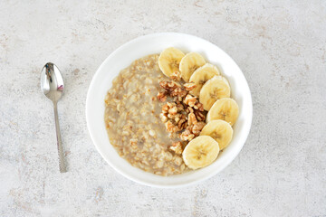 a bowl of oatmeal with bananas and oats and nuts top view