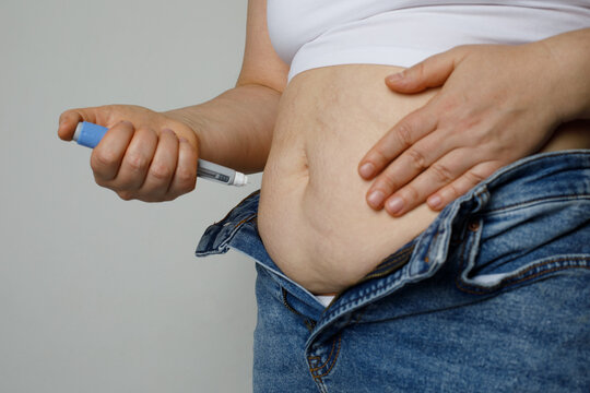 Woman taking an insulin or semaglutide shot at home