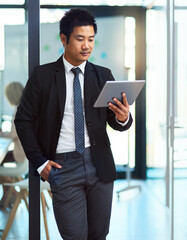 Fototapeta premium Businessman, tablet and reading in office for news, information and preparation for presentation. Speaker, technology and article at window for update, new ideas or economy report for company growth