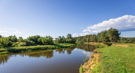 A river with a green forest on the left bank
