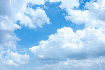A bright blue sky with fluffy white clouds