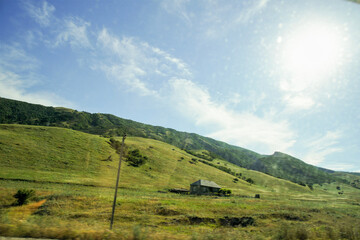 Lonely house on green hills.