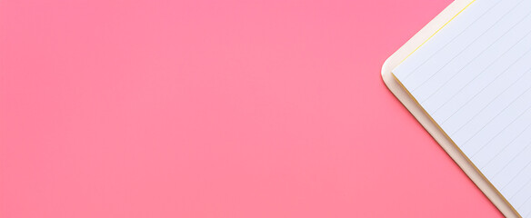Flat lay paper notebook on pink background, workspace concept. Top view, banner, with copy space