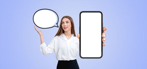 Woman showing empty speech bubble and smartphone screen on light