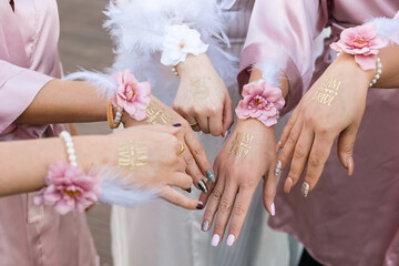 A celebration of friendship and beauty, as the bride and her bridesmaids show their matching hands...