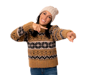 Happy woman in winter clothing pointing to camera isolated over transparent background.