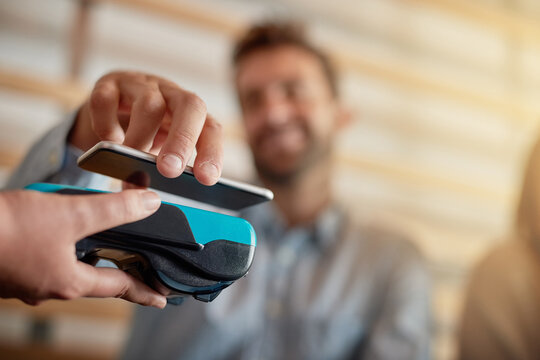 Hand, payment and phone with customer in coffee shop for fintech or nfc bill transaction closeup. App, bank and contactless with person in cafe or restaurant for transfer in small business startup