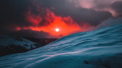  A snow-covered hill beneath a cloudy sky Sun sets in the distance, clouds in the foreground