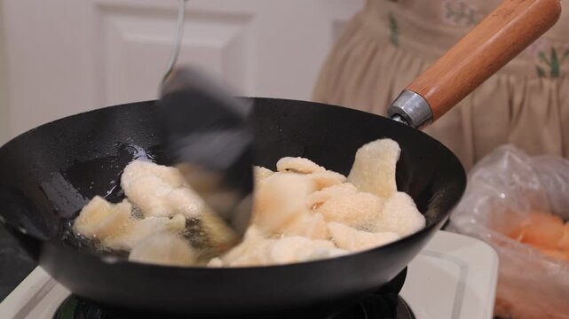 Process Deep Frying Crackers in the Hot Oil, Kitchen Step by Step. Goreng Kerupuk, Indonesian Crackers