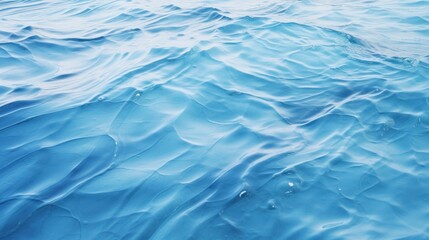 Gentle blue wave patterns on water seen from above creating an abstract visual reminiscent