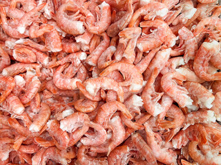 Frozen shrimps prawns. Raw shrimp background. Pile of frozen shrimps background.