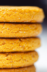 A stack of yellow cookies with a white background