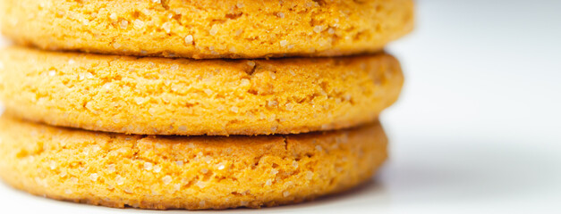 A stack of yellow cookies with a white background