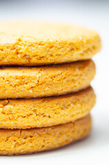 A stack of yellow cookies with a white background